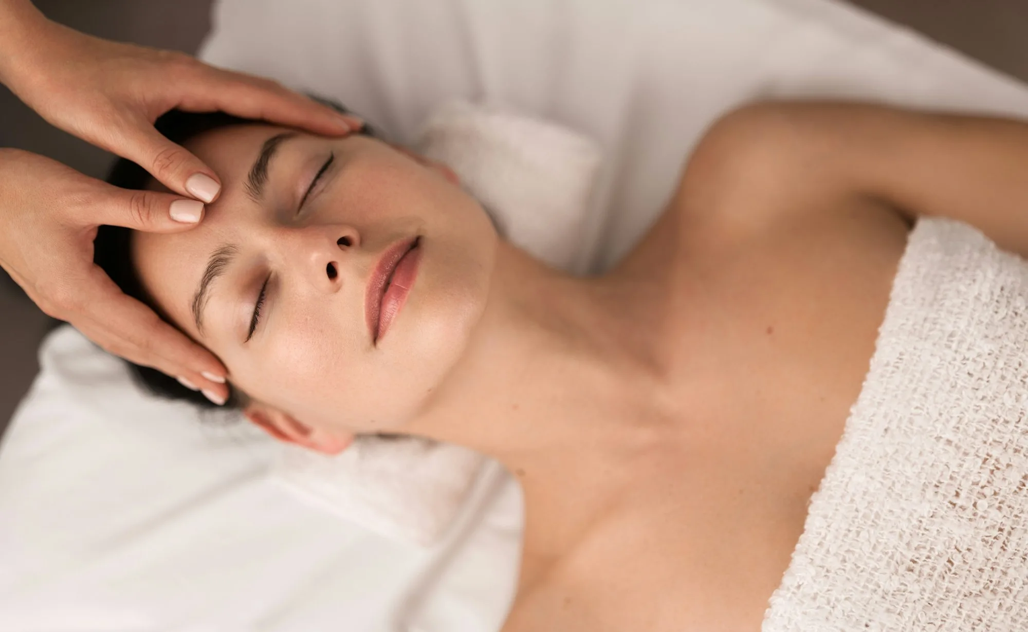 Calm woman with closed eyes at massage