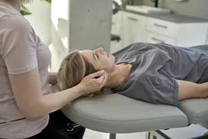 Female physical therapist massaging her patient