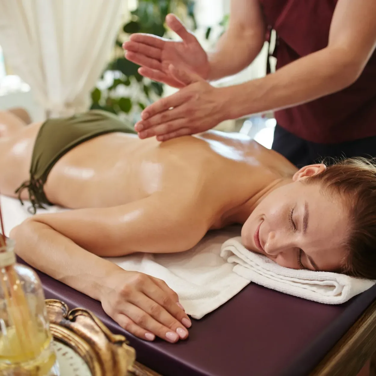 Smiling Woman Enjoying Massage in SPA