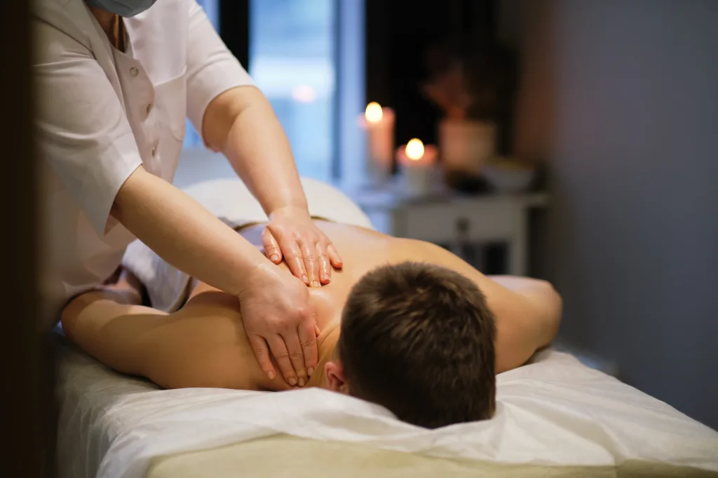 Close-up of man enjoying in relaxing back massage . Man relaxing on massage table receiving massage