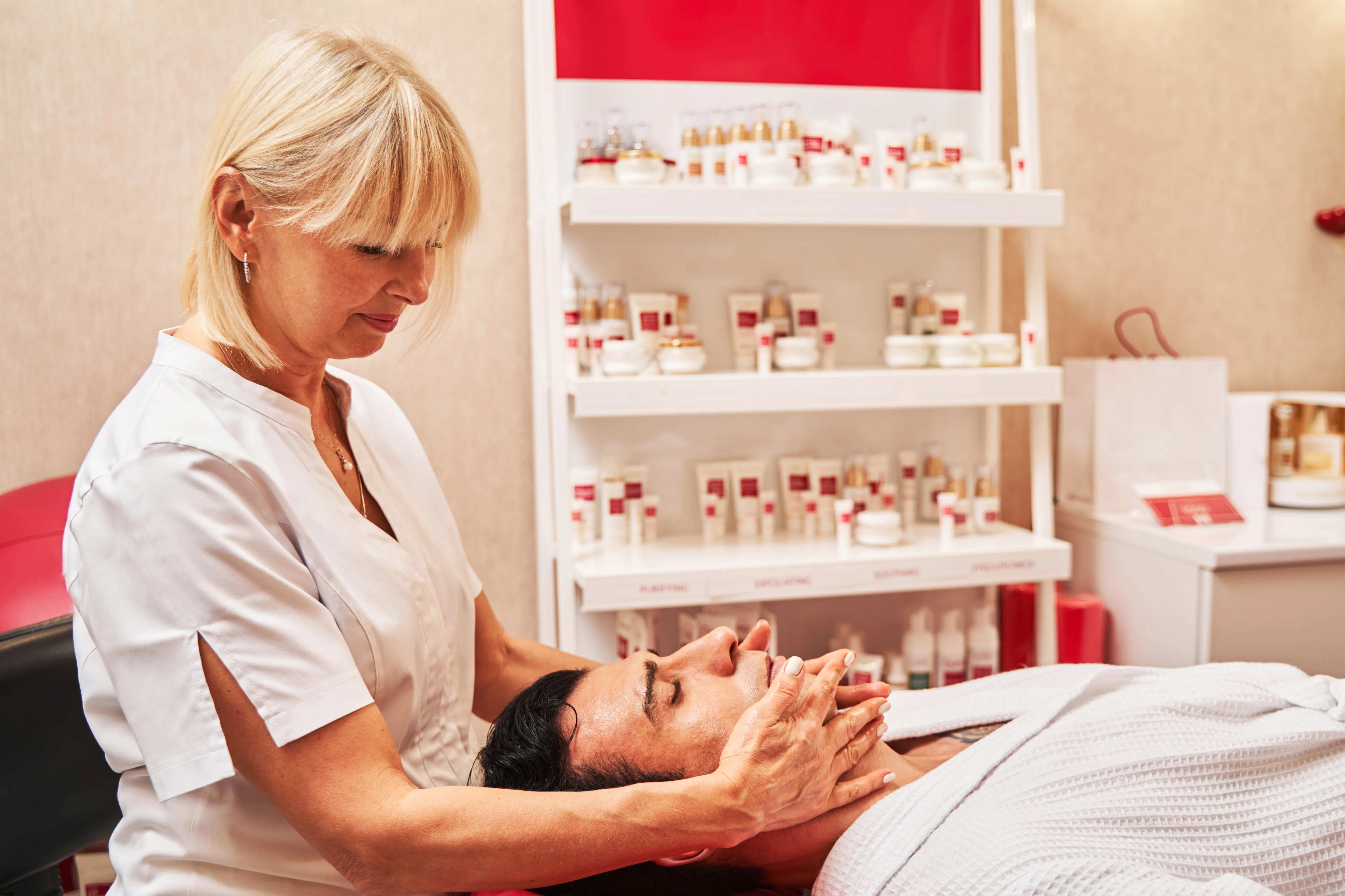 Female massage therapist doing chin massage with hands