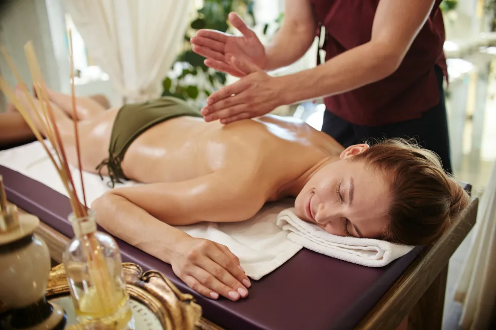 Smiling Woman Enjoying Massage in SPA