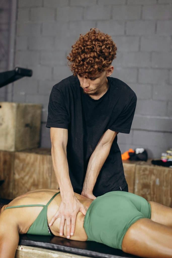 A man doing a back massage on a woman