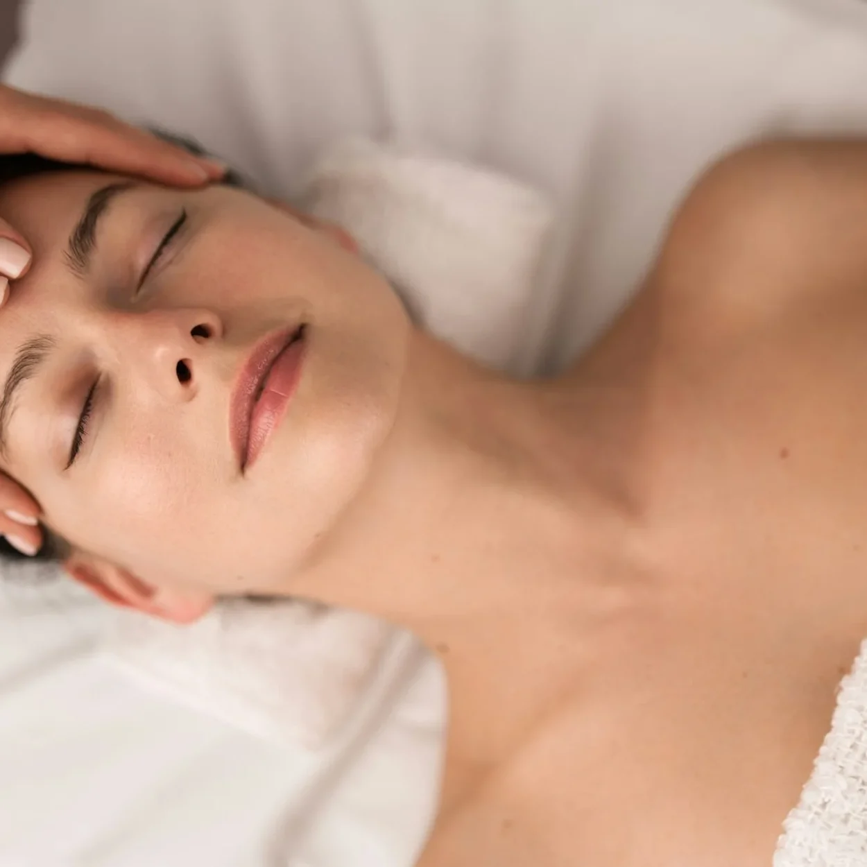 Calm woman with closed eyes at massage