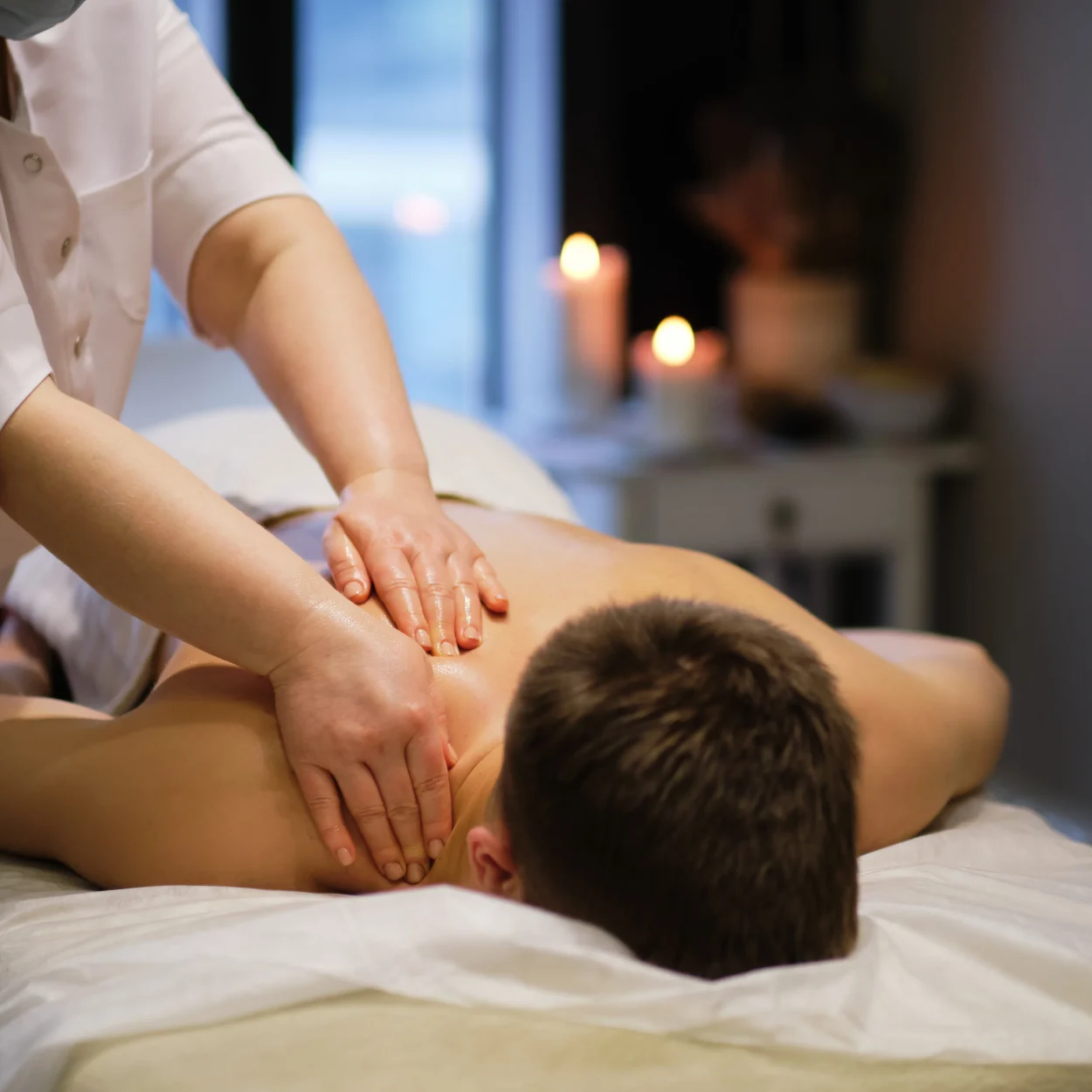 Close-up of man enjoying in relaxing back massage . Man relaxing on massage table receiving massage